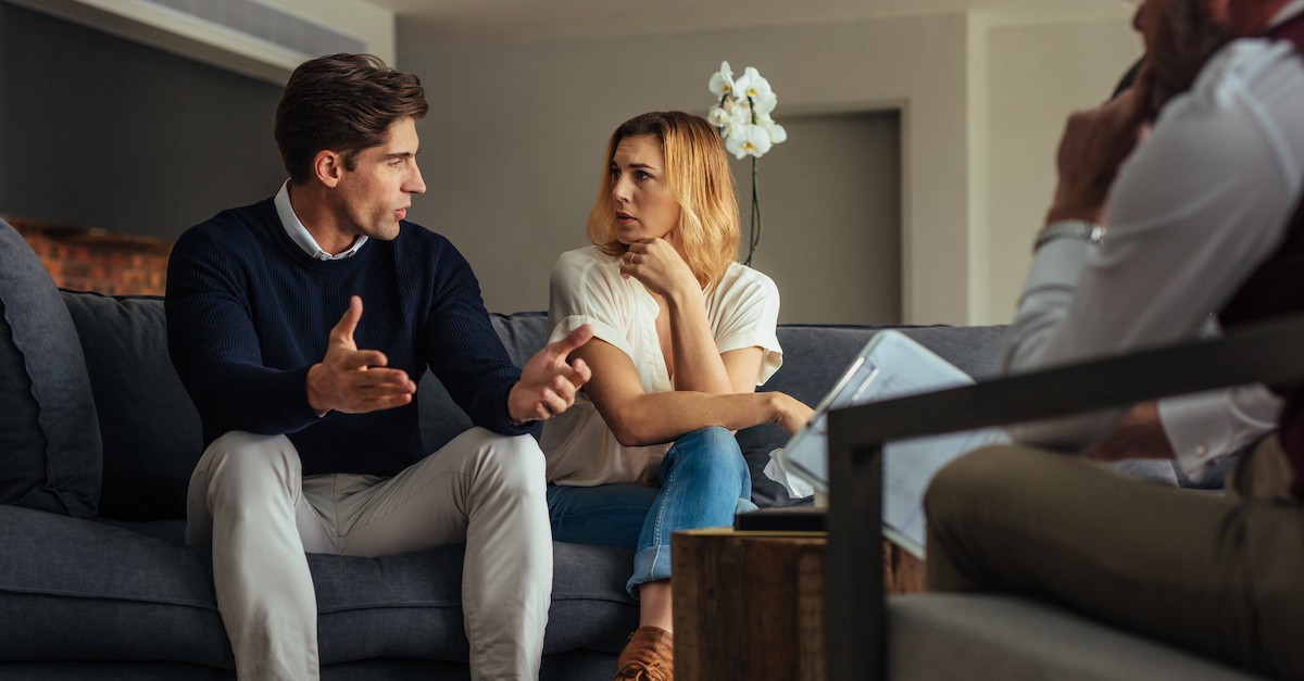 couple talking in marriage counseling; the devastating impact of an affair.